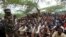 FILE - Members of the militant group al Shabab listen to a Somalia government soldier after their surrender to the authorities in Mogadishu, Sept. 24, 2012.