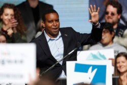 FILE - Joe Neguse, Democratic candidate for U.S. House District 2 in Colorado, greets voters on the campus of the University of Colorado, in Boulder, Oct. 24, 2018.