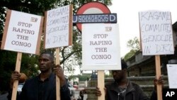 Protesters stand outside Arundel House where President of the Republic of Rwanda, Paul Kagame, deliverers the annual Oppenheimer Lecture, London, Sept. 16, 2010.