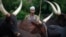 FILE - A man from the Peul tribe stands in front of cattle at a village outside Bambari.