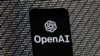 ARCHIVO - El logotipo de OpenAI aparece en un teléfono celular frente a la pantalla de una computadora, el 9 de marzo de 2023, en Boston. 