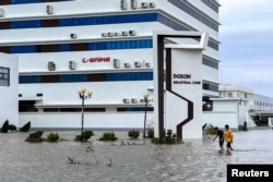 People wade through a flooded street following the impact of Typhoon Yagi, Hai Phong, Vietnam, September 8, 2024. (REUTERS/Minh Nguyen)