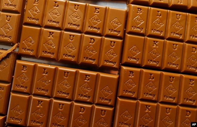 Candy bars marked with Colorado's new required diamond-shaped stamp noting that the product contains marijuana, are displayed in Denver on September 19, 2016. (AP Photo/David Zalubowski, File)