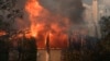 Fueled by high winds, the Palisades Fire burns through property in the Pacific Palisades neighborhood of Los Angeles, Jan. 8, 2025.