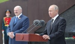 FILE - Russian President Vladimir Putin and Belarusian President Lukashenko attend a ceremony unveiling a WW II memorial near Rzhev in Tver Region, Russia, June 30, 2020. (Sputnik/Mikhail Klimentyev/Kremlin via Reuters).