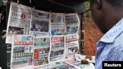 FILE - Newspapers with various front page headlines on the Chibok girls and their possible release are displayed at a news stand in Abuja, Nigeria, Oct. 18, 2014.