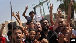 Libyans celebrate the liberation of their district of Qasr Bin Ghashir in Tripoli, Libya, August 27, 2011.