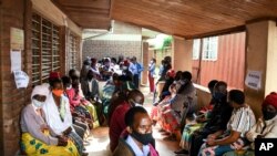 FILE - People wait to receive the AstraZeneca COVID-19 vaccine at Ndirande Health Centre in Blantyre, Malawi, March 29, 2021.