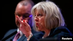 FILE - Britain's Home Secretary Theresa May said a panel of legal and child-protection experts would investigate how public agencies handle child-abuse allegations July 7, 2014. 