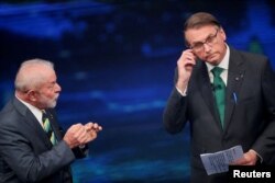 FILE - Brazil's former President Luiz Inacio Lula da Silva and Brazil's President Jair Bolsonaro participate in a candidates' debate ahead of a runoff election, in Sao Paulo, Brazil, October 16, 2022. (REUTERS/Mariana Greif/File Photo)