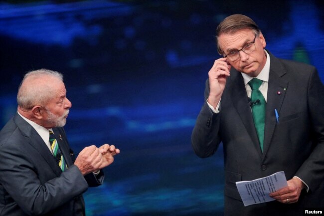 FILE - Brazil's former President Luiz Inacio Lula da Silva and Brazil's President Jair Bolsonaro participate in a candidates' debate ahead of a runoff election, in Sao Paulo, Brazil, October 16, 2022. (REUTERS/Mariana Greif/File Photo)