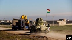 Kurdish peshmerga forces prepare for battle against the Islamic State group, near the Mosul Dam, in Iraq, Jan. 20, 2015.