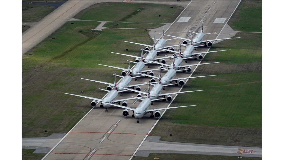 American Airlines passenger planes are parked on a runway due to flight reductions to slow the spread of coronavirus disease (COVID-19), at Tulsa International Airport in Tulsa, Oklahoma, March 23, 2020.