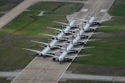 American Airlines passenger planes are parked on a runway due to flight reductions to slow the spread of coronavirus disease (COVID-19), at Tulsa International Airport in Tulsa, Oklahoma, March 23, 2020.