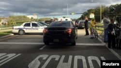 Police patrol the area outside Marjory Stoneman Douglas High School following a school shooting incident in Parkland, Florida, Feb. 15, 2018. 