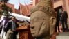 The head of Male Divinity statue is on display during a ceremony after the artifacts were returned back from Norwegian collector Morten Bosterud, at Cambodian National Museum in Phnom Penh, Cambodia, Tuesday, Oct. 20, 2015. Cambodia welcomed home two stone statue from golden Angkor era that was looted from a temple during the country's civil war and spent the past three decades in abroad. (AP Photo/Heng Sinith)