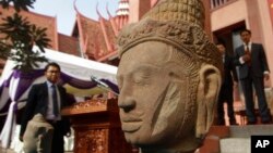 The head of Male Divinity statue is on display during a ceremony after the artifacts were returned back from Norwegian collector Morten Bosterud, at Cambodian National Museum in Phnom Penh, Cambodia, Tuesday, Oct. 20, 2015. Cambodia welcomed home two stone statue from golden Angkor era that was looted from a temple during the country's civil war and spent the past three decades in abroad. (AP Photo/Heng Sinith)