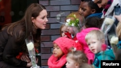 FILE - Britain's Catherine, Duchess of Cambridge talks to children as she leaves the Fostering Network offices in North London January 16, 2015.  The Fostering Network is a charity which provides  information about fostering, gives support and advice to its members, and campaigns to improve foster care.