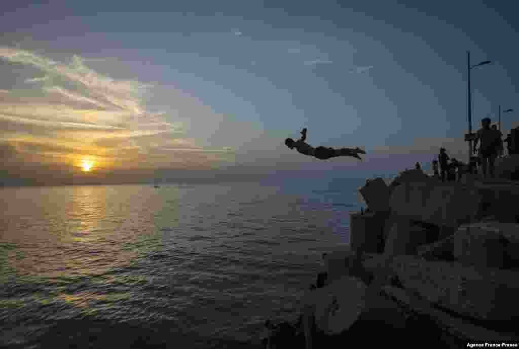 Palestinians jump into the Mediterranean Sea on Oct. 29, 2021 in Gaza City.