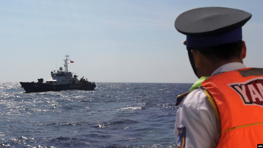 FILE - A Vietnamese coast guard officer looks at a Vietnamese coast guard vessel in the South China Sea, May 14, 2014. Vietnam has faced increasingly aggressive Chinese territorial claims to sections of the South China Sea, where Vietnamese maritime patrols have faced off against Chinese naval forces.