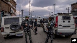 Indian security forces stand guard near the site of a grenade attack by suspected rebels on the eve of Indian Republic Day in Srinagar, Indian-controlled Kashmir, Jan. 25, 2022.