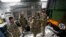 FILE - British military personnel gathered next to a French army truck inside a British C17 transport plane at an army base in Evreux, 90 kms (56 miles) north of Paris, Jan. 14, 2013. 
