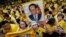 FILE - Supporters of Thailand's King Bhumibol Adulyadej, carrying portraits and banners, are seen celebarting his 87th birthday, in Bangkok, Thailand, Dec. 5, 2014.