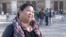 American tourist Dawn Mabalon stands in front of Notre Dame Cathedral in Paris, France, Nov. 15, 2015. (Photo - L. Bryant/VOA)