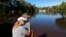 Dianna Wood, embraces her husband Lynn, as they look out over their flooded property as the Little River continues to rise in the aftermath of Hurricane Florence in Linden, North Carolina, Sept. 18, 2018. 