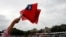 An audience member waves Taiwanese flags during the National Day celebrations in Taipei, Taiwan, Oct. 10, 2018.