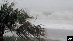 Rains and waves from Hurricane Irene batter the shore in downtown Myrtle Beach, South Carolina, August 26, 2011