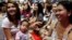 FILE - Filipino mothers hold their babies during a one-minute simultaneous breastfeeding event, as a way to promote breastfeeding, in Manila, Philippines, Aug. 5, 2017. 