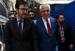 FILE - U.S. special representative for Afghan peace and reconciliation Zalmay Khalilzad (R) arrives for a forum talk at Tolo TV, in Kabul, Afghanistan, April 28, 2019.