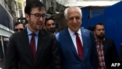 FILE - U.S. special representative for Afghan peace and reconciliation Zalmay Khalilzad (R) arrives for a forum talk at Tolo TV, in Kabul, Afghanistan, April 28, 2019.
