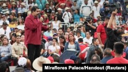 Venezuela's President Nicolas Maduro, left, speaks during a gathering in support of him and his proposal for the National Constituent Assembly in Caracas, Venezuela, June 27, 2017. 