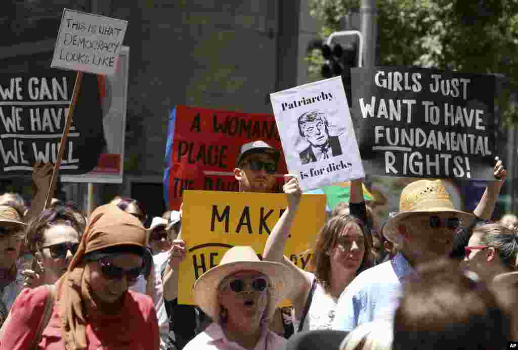 People file through the streets with placards during the Women&#39;s March against the start of Donald Trump&#39;s presidency, in Sydney, Australia, Saturday, Jan. 21, 2017. (AP Photo/Rick Rycroft)