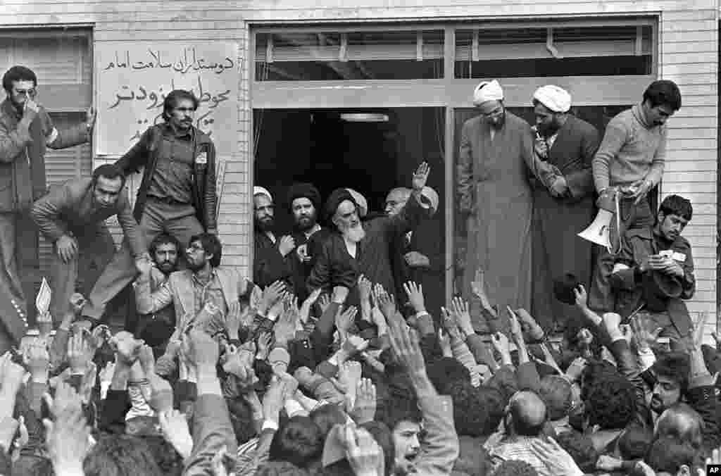 رهبر بنیادگرای اسلامی آیت الله روح الله خمینی یکروز بعد از ورود به تهران در بالکن محل سکونتش برای پیروان و هوادارانش دست تکان می دهد. هزاران نفر در خیابان های اطراف محل اقامت آیت الله اجتماع کرده اند – تهران، ۱۳ بهمن ۱۳۵۷