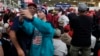 Supporters take a photo as Republican presidential nominee former President Donald Trump speaks at a campaign event at Dane Manufacturing in Waunakee, Wisconsin, Oct. 1, 2024.