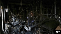 A Houston Fire Department Arson Investigator inspects the scene following a fire at the Quba Islamic Institute in Houston, Texas, Feb. 13, 2015. 