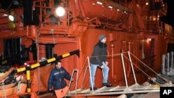 Survivors of a ship fire on Tanzania's vessels, the Candy and the Maestro, in the Kerch Strait arrive at the Kerch sea port, Crimea, Jan. 22, 2019.