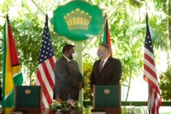 U.S. Secretary of State Mike Pompeo, right, speaks with Guyana's President Mohamed Irfaan Ali during a joint press conference in Georgetown, Sept. 18, 2020.