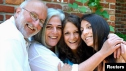 U.S. aid contractor Alan Gross poses with wife and daughters in this undated family photograph released on October 23, 2010. REUTERS/Family Photograph/Handout.