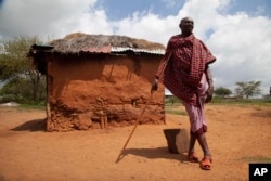 Lesian Ole Sempere, a Samburu elder, poses for a photograph outside his house in Lekiji Village, Laikipia county, Kenya, on July 26, 2024.