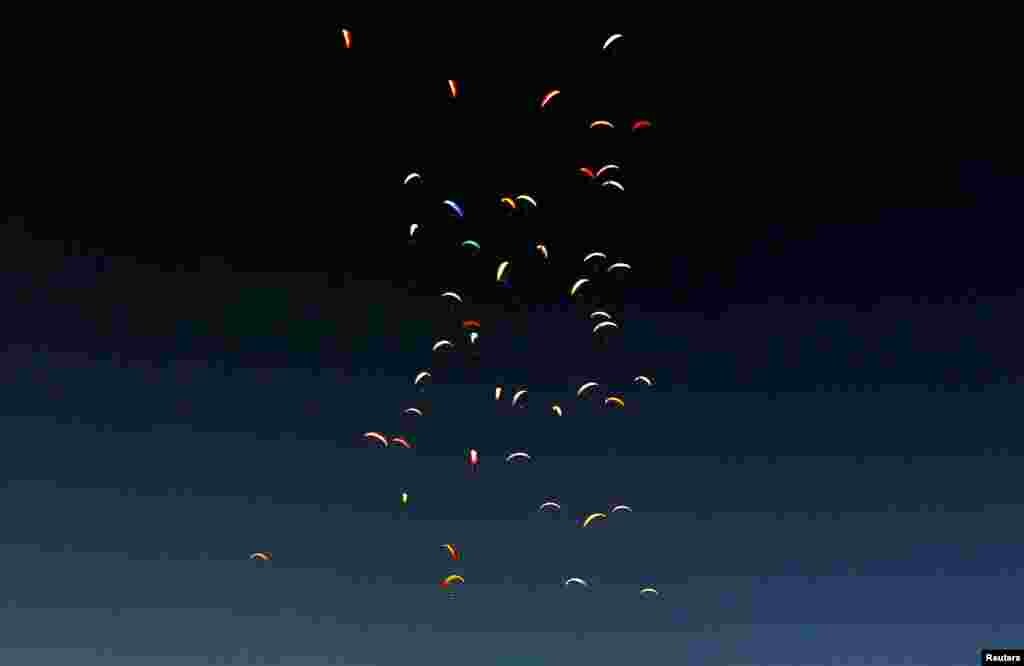 Pilots fly their paragliders during 16th FAI Paragliding World Championship in Krusevo, North Macedonia.