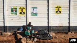 A cobler mends shoes at a make shift shop on the street in Gweru, Zimbabwe, on July 16, 2023.