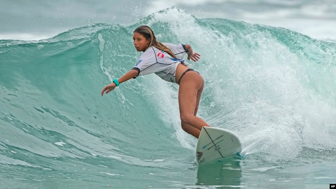 Luana Reis, 14, rides a wave during a local surf tournament in Maresias beach, Sao Sebastiao, Brazil, Nov. 26, 2021.