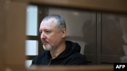 FILE - Igor Girkin, a hardline nationalist critic of Russian President Vladimir Putin, sits inside a defendant's cage at Moscow City Court on Oct. 17, 2023. Prosecutors asked a judge to jail Girkin for nearly five years on extremist charges on Jan. 18, 2024.