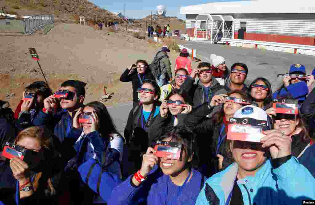 People test their special solar glasses before the solar eclipse in La Silla European Southern Observatory (ESO) at Coquimbo, Chile.