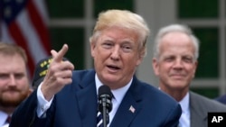 President Donald Trump speaks before signing the "VA Mission Act of 2018" during a ceremony in the Rose Garden of the White House in Washington, June 6, 2018. 