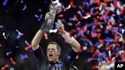 New England Patriots' Tom Brady raises the Vince Lombardi Trophy after defeating the Atlanta Falcons in overtime at the NFL Super Bowl 51 football game on Feb. 5, 2017, in Houston.